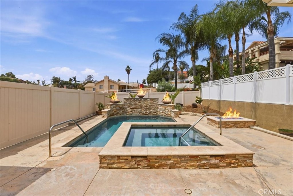 14202 Meadowlands Drive Riverside, CA 92503 - Photo 48 of 60 a view of a swimming pool with a lounge chairs