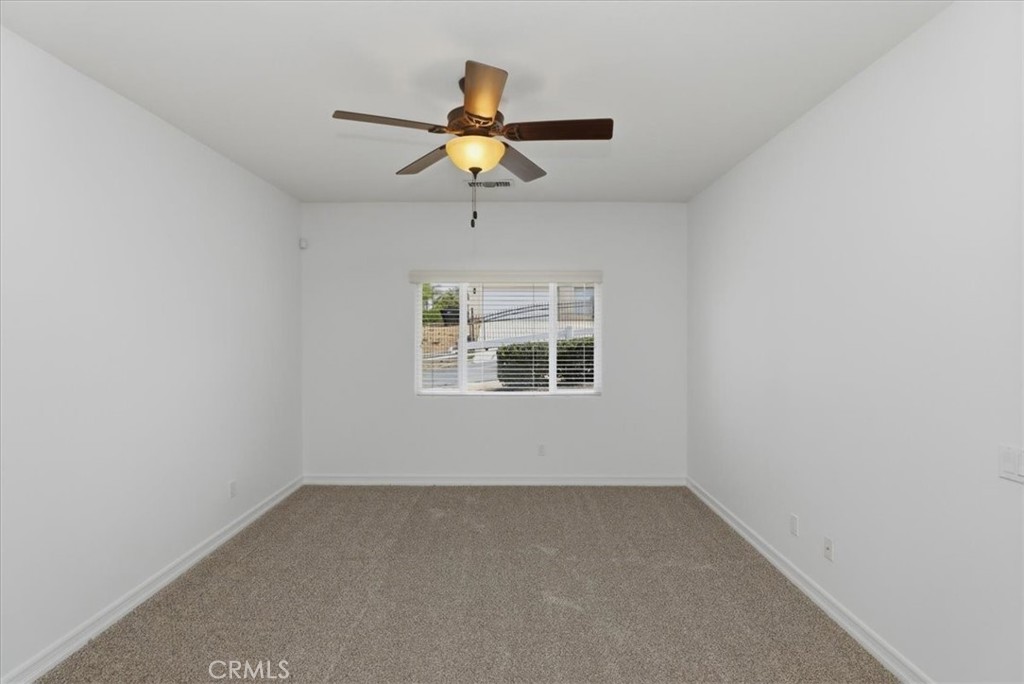 14202 Meadowlands Drive Riverside, CA 92503 - Photo 54 of 60 an empty room with a window and a ceiling fan