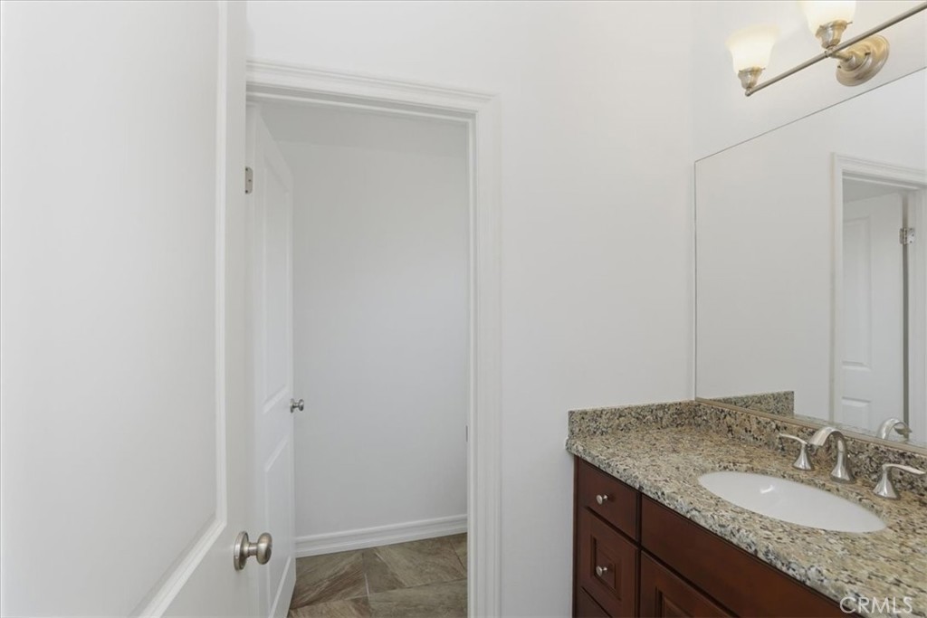 14202 Meadowlands Drive Riverside, CA 92503 - Photo 55 of 60 a bathroom with a granite countertop sink and a mirror