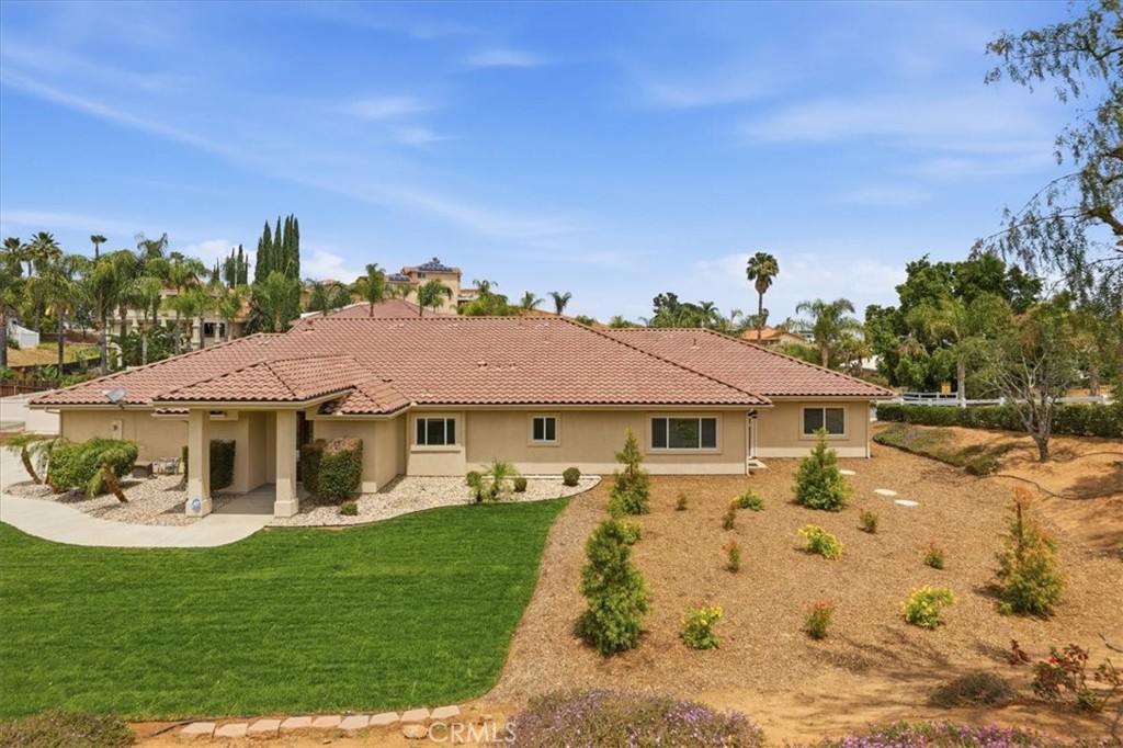 14202 Meadowlands Drive Riverside, CA 92503 - Photo 6 of 60 a view of a white house with a big yard and potted plants