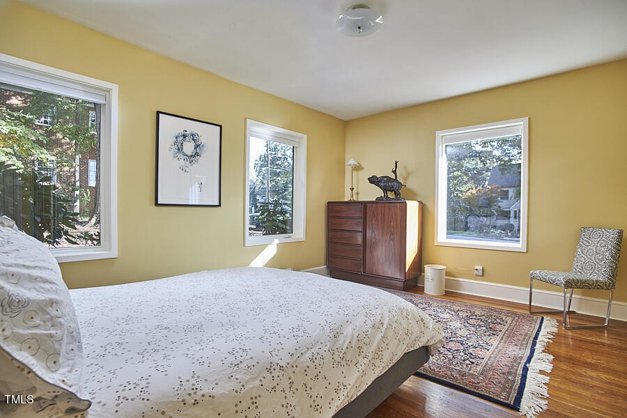 2620 Fairview Road Raleigh, NC 27608 - Photo 16 of 31 a bedroom with a bed and wooden floor