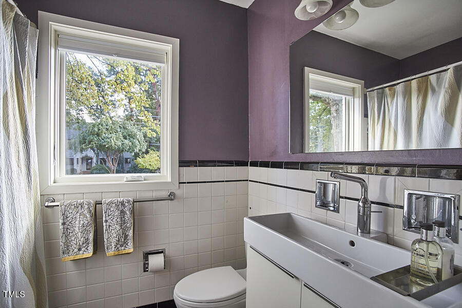 2620 Fairview Road Raleigh, NC 27608 - Photo 17 of 31 a bathroom with a sink toilet and mirror