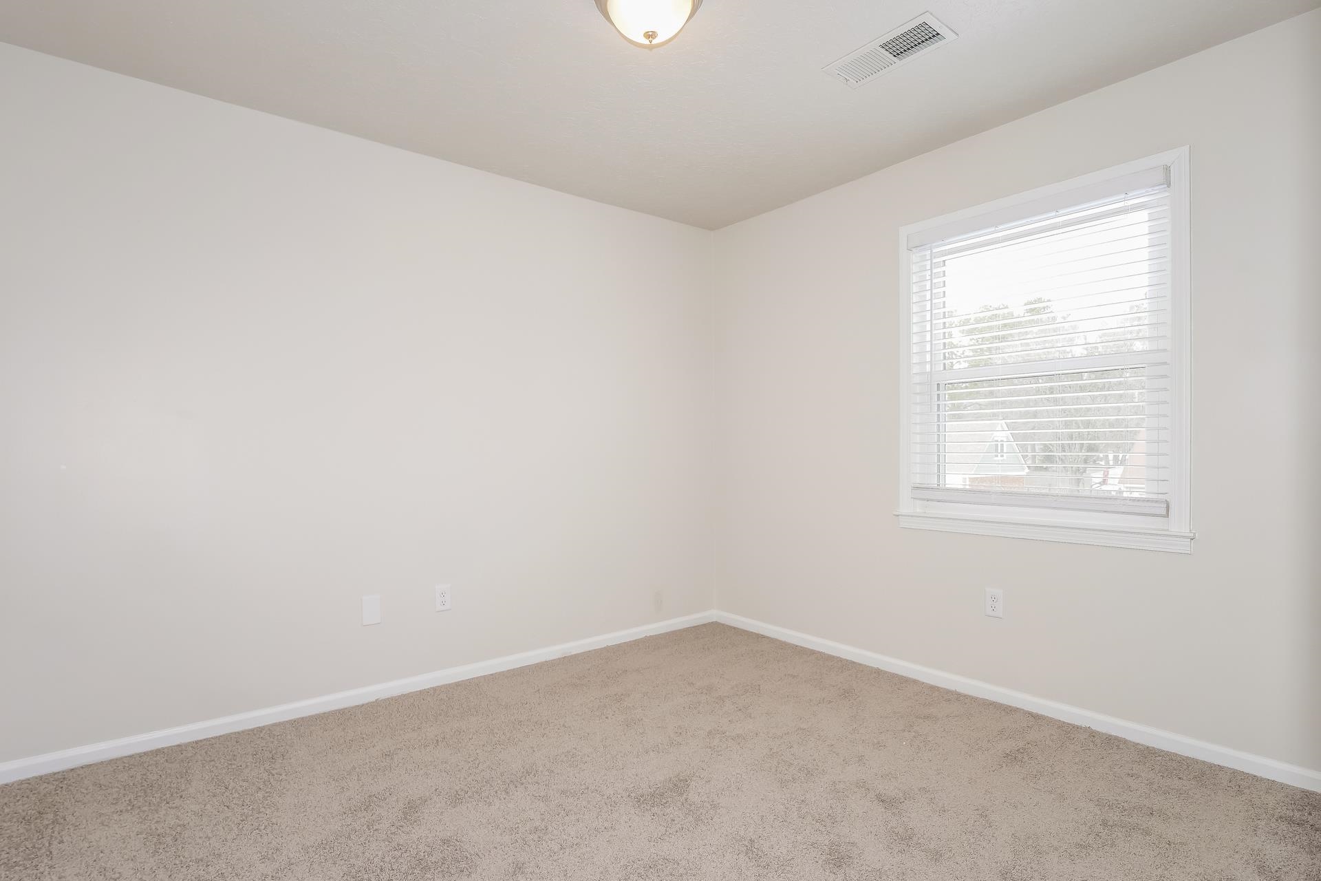207 East Pecan Valley Street Collierville, TN 38017 - Photo 9 of 18 Unfurnished room featuring carpet flooring and baseboards