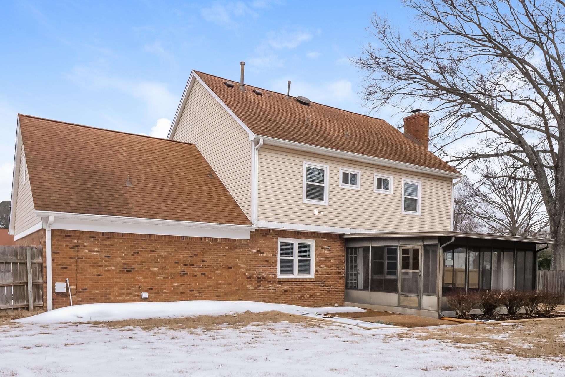 207 East Pecan Valley Street Collierville, TN 38017 - Photo 11 of 18 Snow covered property featuring brick siding, a chimney, a sunroom, and roof with shingles