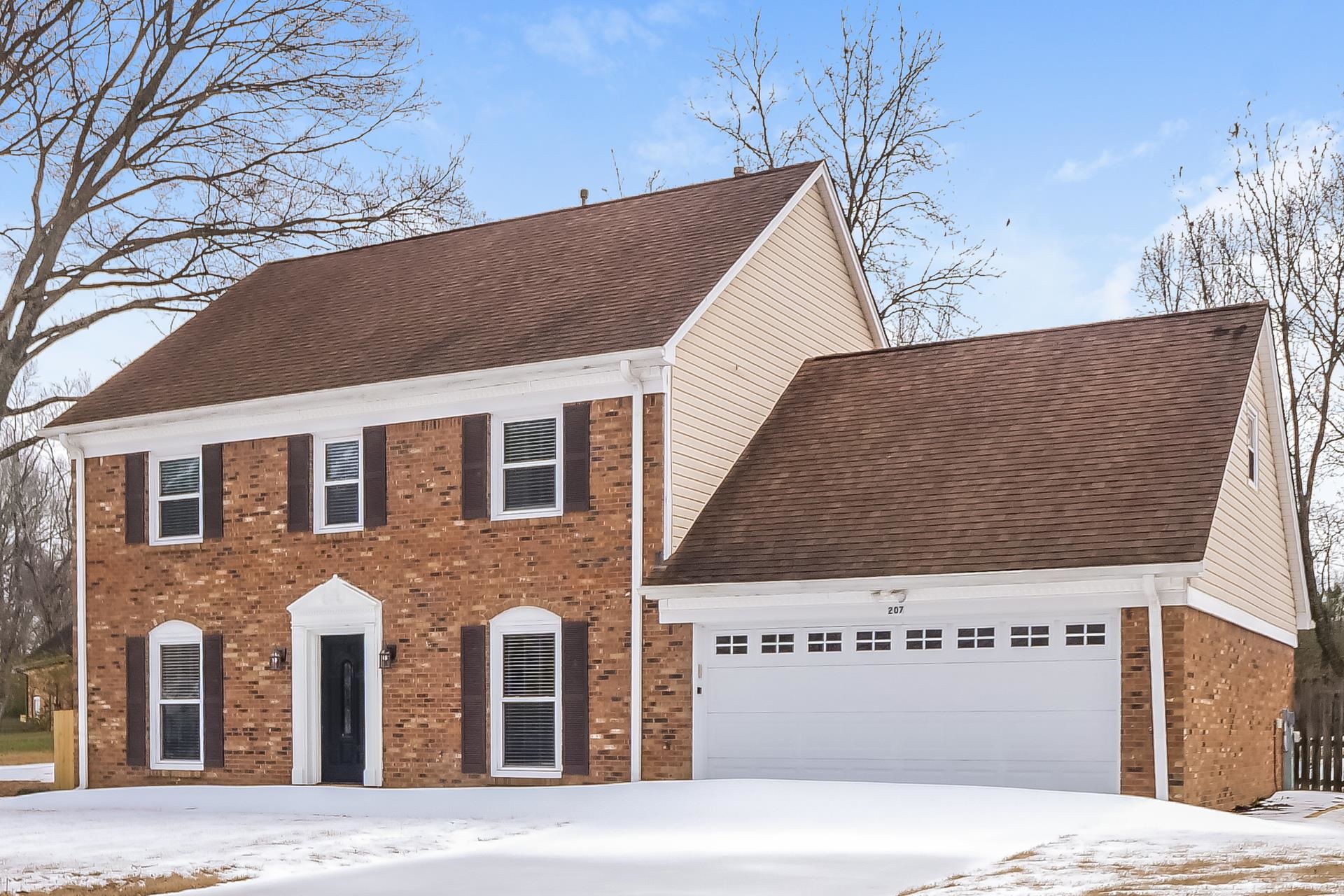 207 East Pecan Valley Street Collierville, TN 38017 - Photo 12 of 18 Colonial house with brick siding, a garage, and a shingled roof