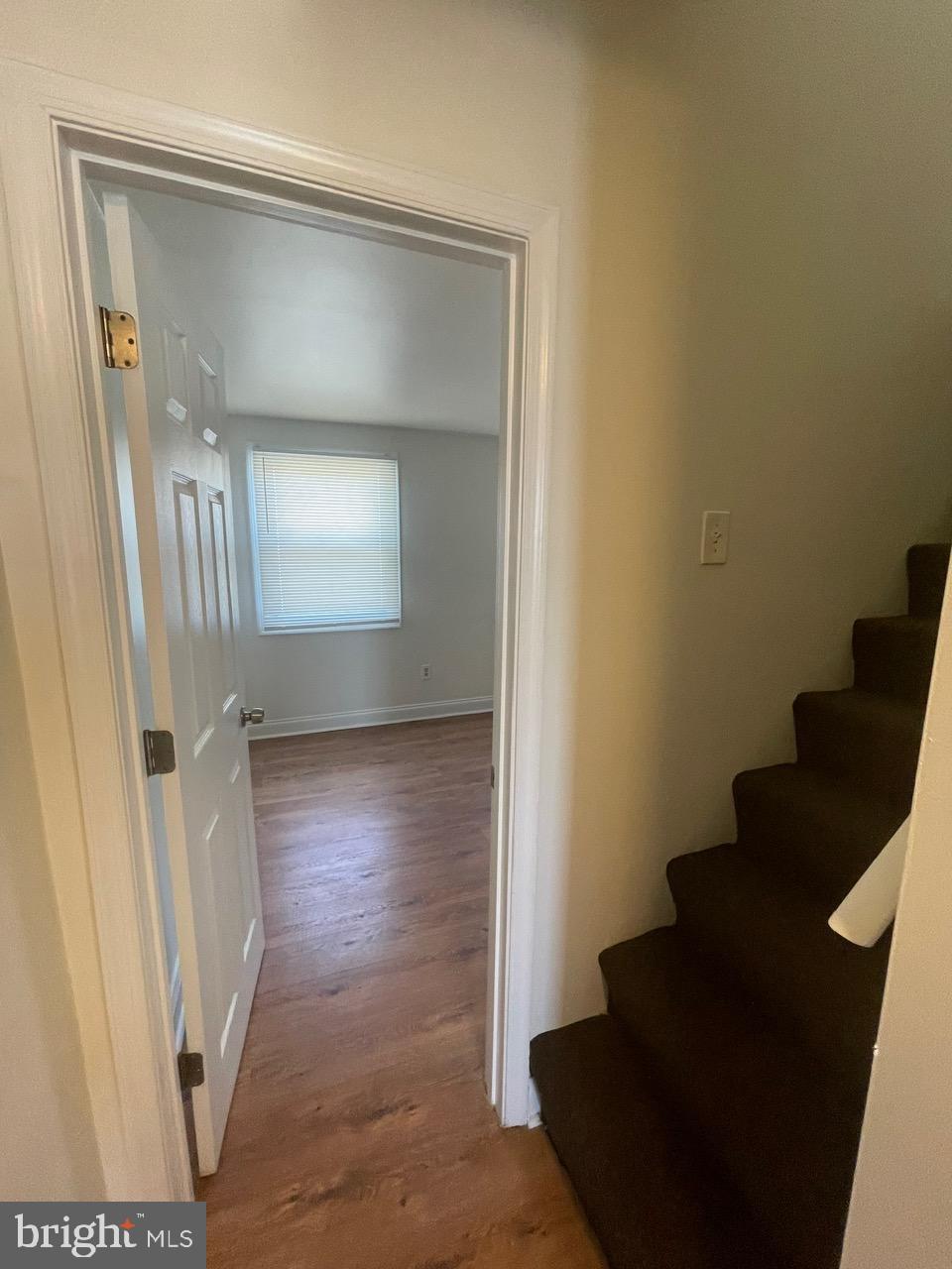 109 Carver Road Dundalk, MD 21222 - Photo 11 of 23 a view of a hallway with wooden floor and staircase