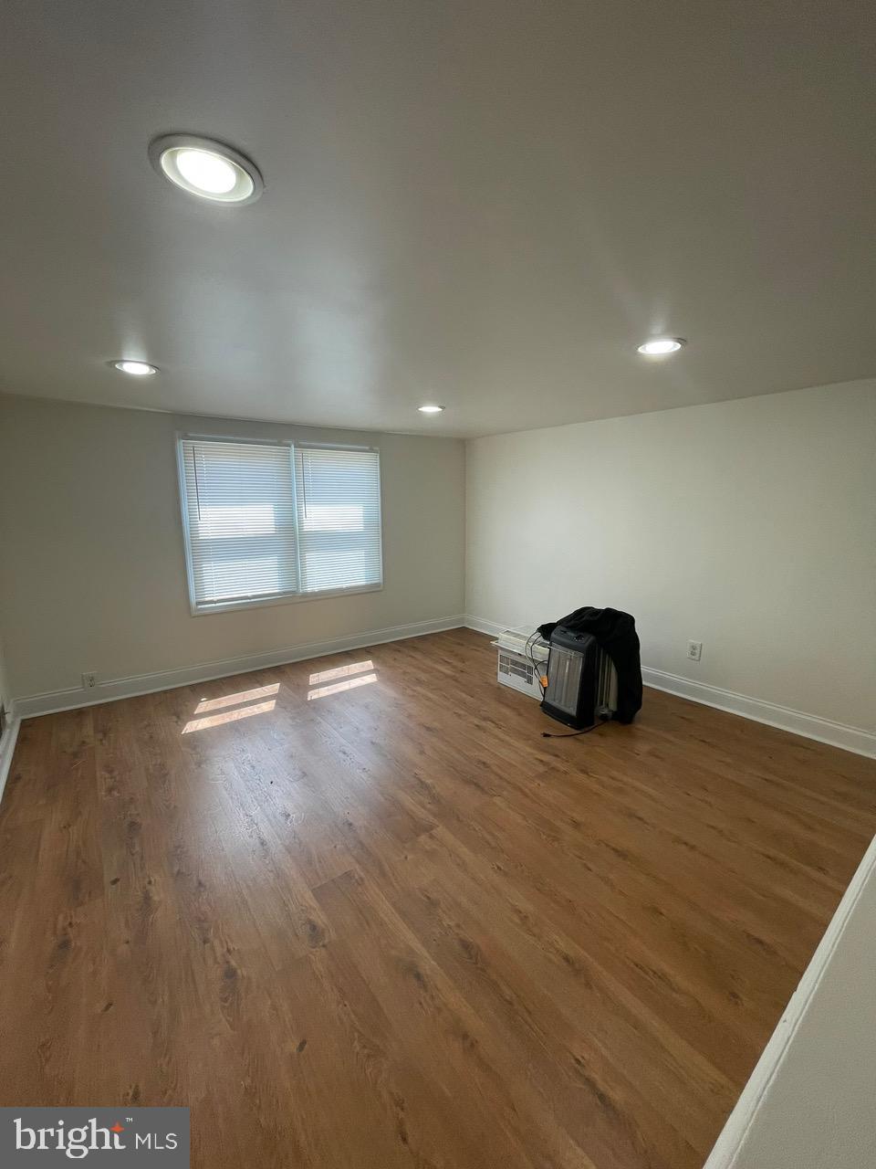 109 Carver Road Dundalk, MD 21222 - Photo 22 of 23 a view of an empty room with wooden floor and a window