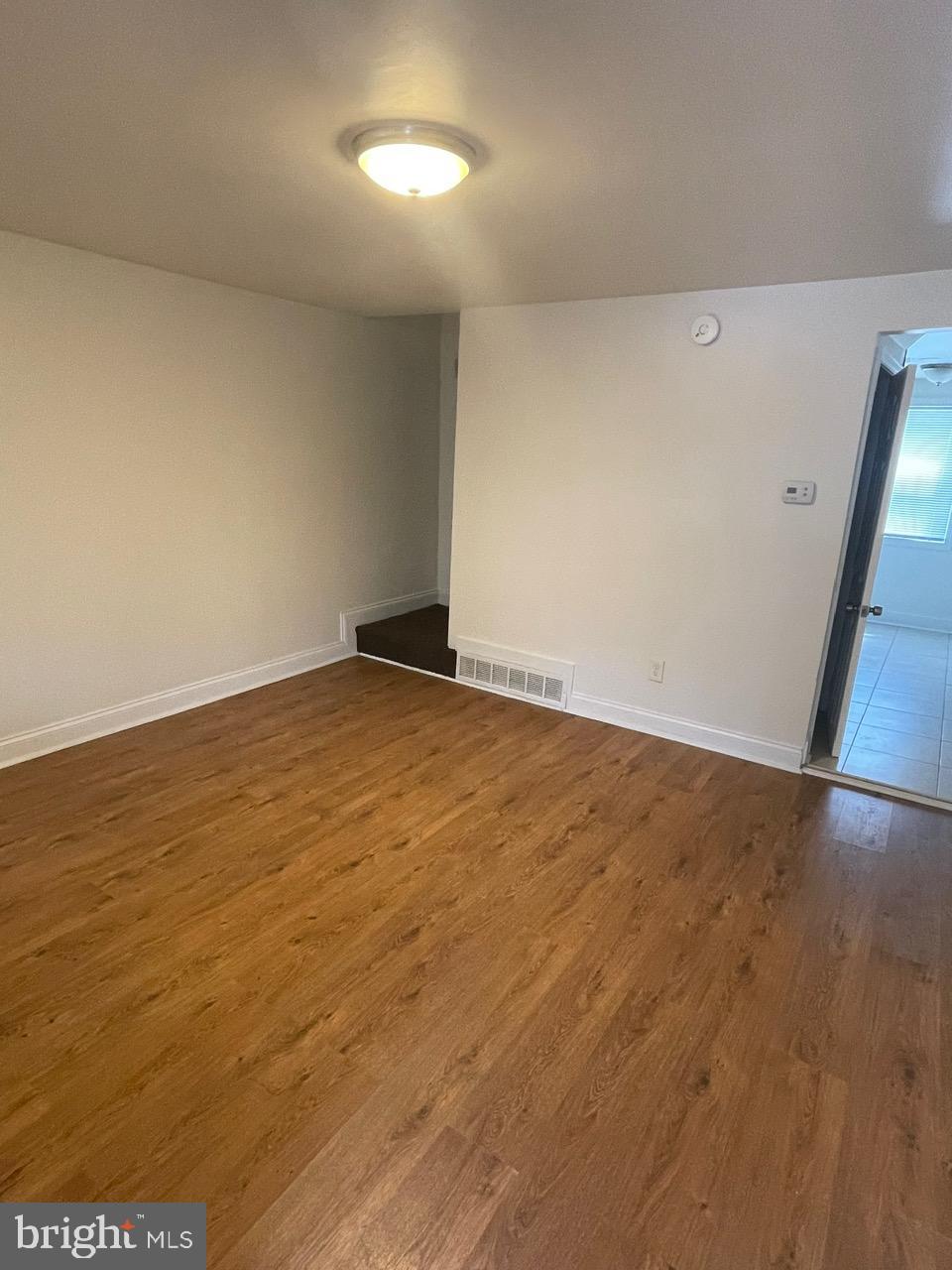 109 Carver Road Dundalk, MD 21222 - Photo 3 of 23 an empty room with wooden floor