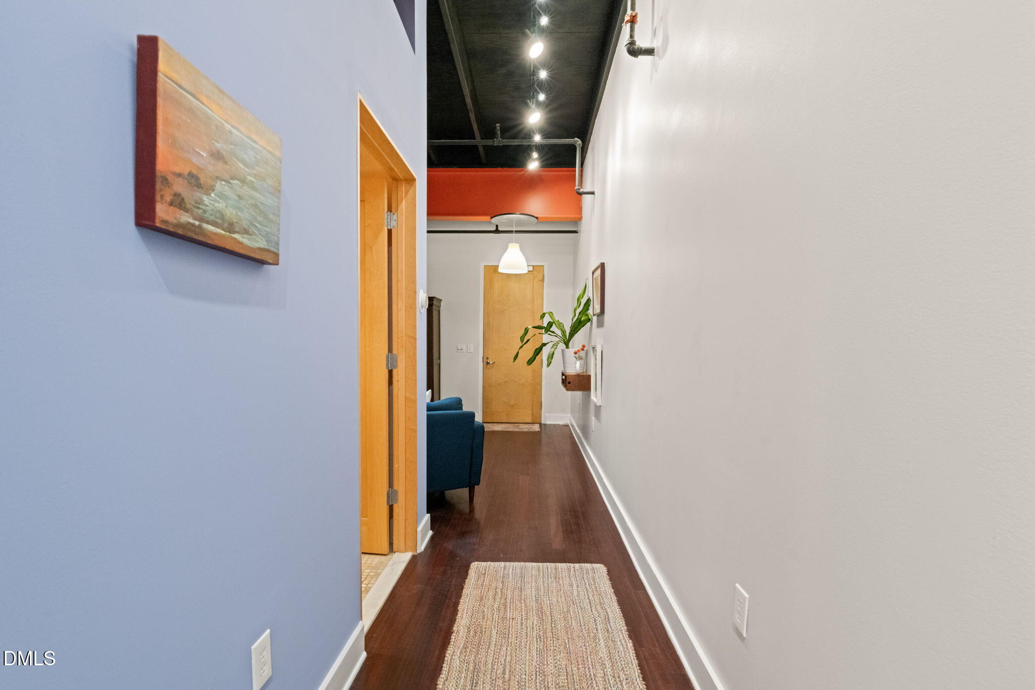 208 Rigsbee Avenue, Unit 206 Durham, NC 27701 - Photo 11 of 36 a view of a hallway with wooden floor and a bathroom