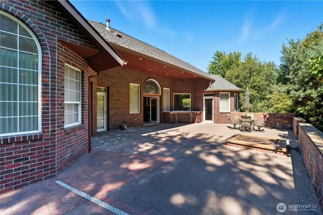 a swimming pool with outdoor seating and yard