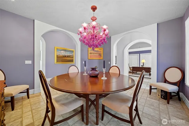 a living room with patio furniture and a large window