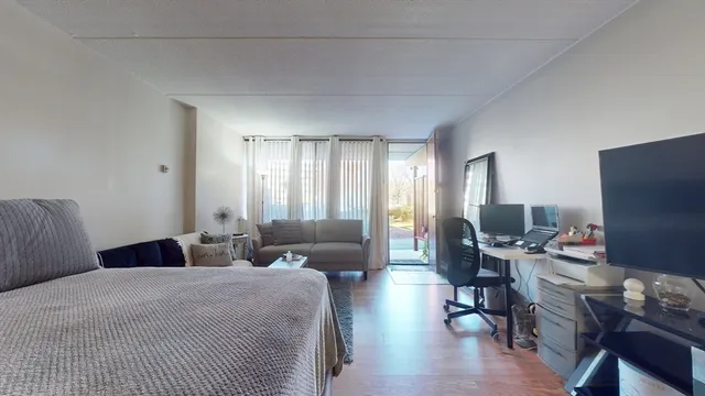 a bedroom with furniture and a flat screen tv