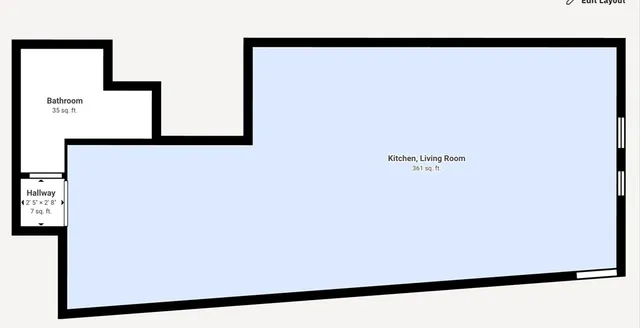 a view of a livingroom with workspace and a couch