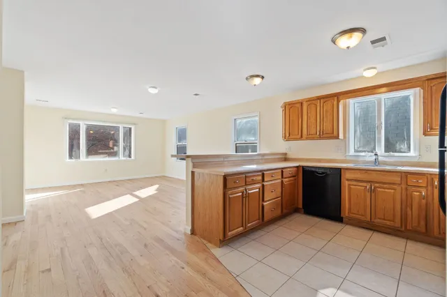 a kitchen with stainless steel appliances granite countertop a stove sink and cabinets