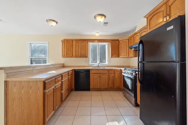 a kitchen with a sink a refrigerator and a stove
