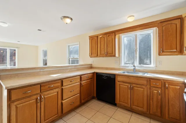 a spacious bathroom with a granite countertop sink and a window
