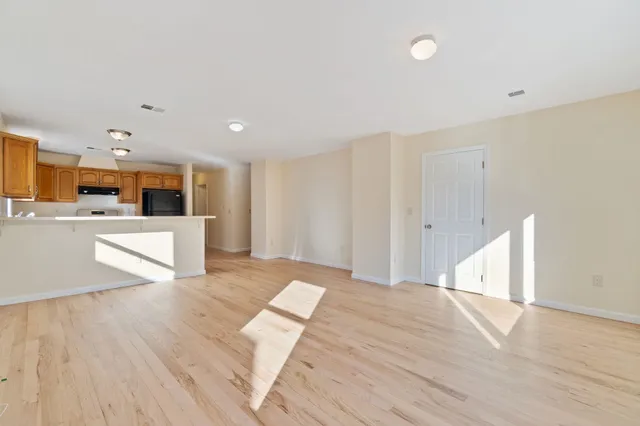 a view of kitchen with cabinets and wooden floor
