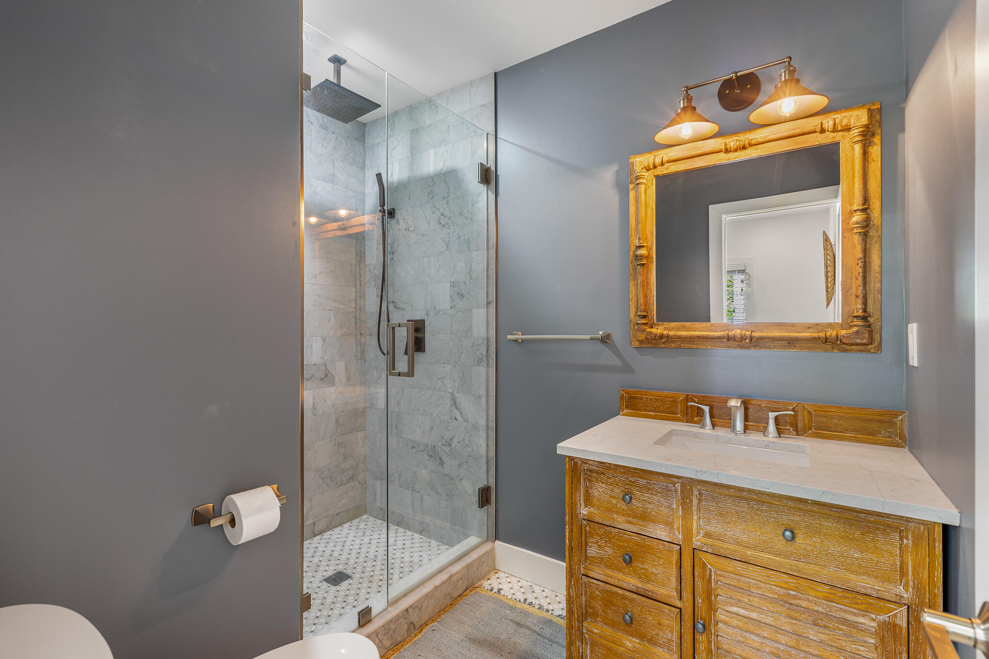 916 Seminary Street Key West, FL 33040 - Photo 20 of 37 a bathroom with a shower a mirror and a sink