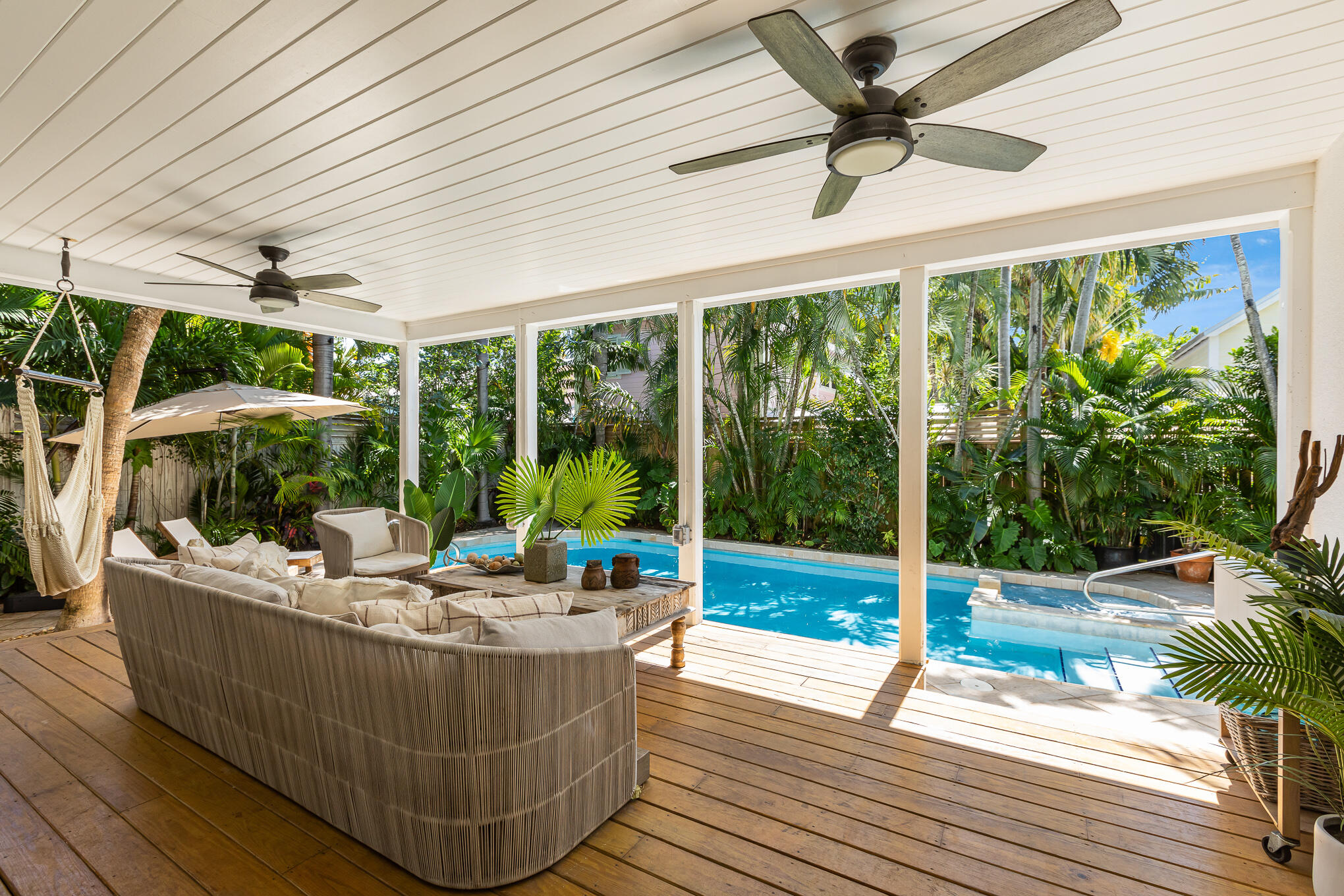 916 Seminary Street Key West, FL 33040 - Photo 26 of 37 a view of a patio with a table chairs and a floor to ceiling window