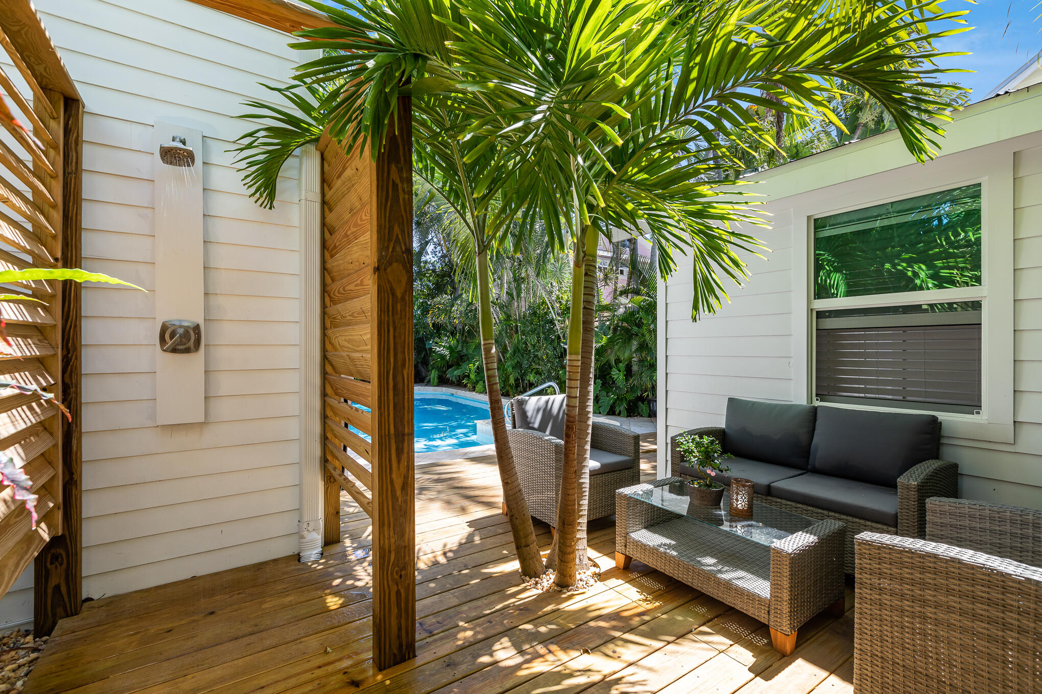 916 Seminary Street Key West, FL 33040 - Photo 32 of 37 a view of a patio with couches and a potted plant on a table and chair