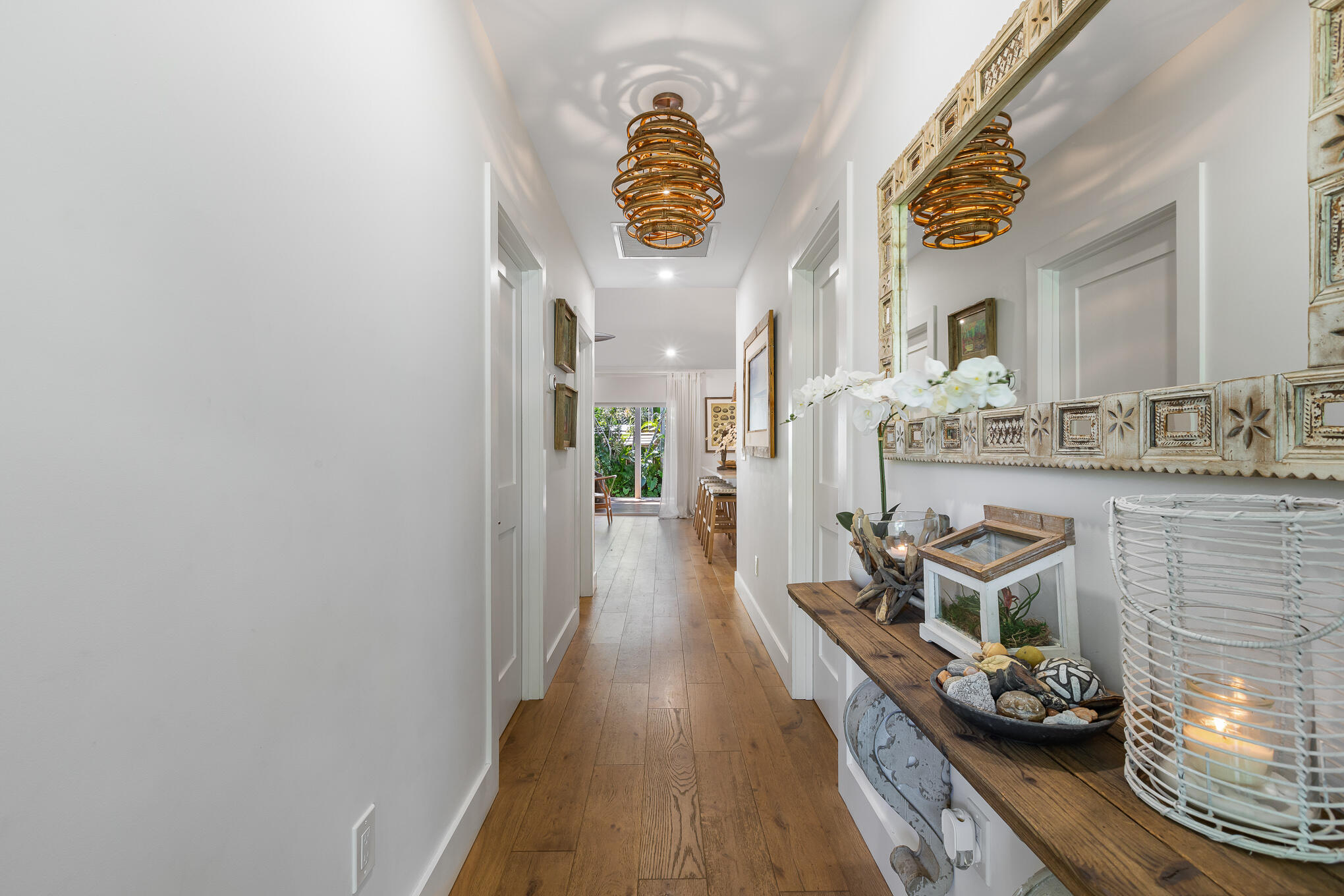 916 Seminary Street Key West, FL 33040 - Photo 8 of 37 a hallway with painting on the wall and a clock on the wall