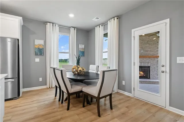 a dining room with furniture and wooden floor