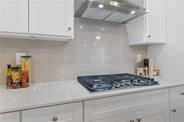 a stove top oven sitting inside of a kitchen