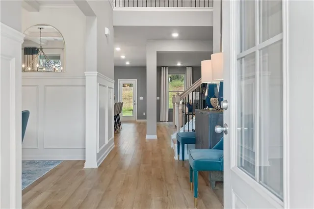 a view of a hallway view with wooden floor and living room