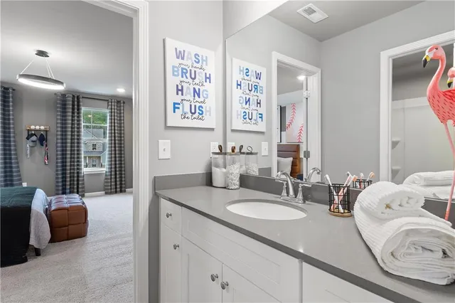 a bathroom with double vanity sinks a shower and a mirror