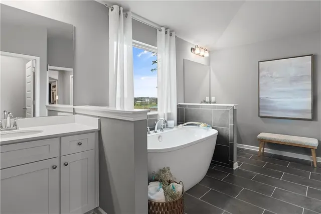 a spacious bathroom with a double vanity sink mirror and bathtub