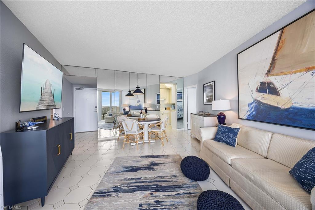 58 North Collier Boulevard, Unit 2101 Marco Island, FL 34145 - Photo 11 of 30 a living room with furniture a rug and a flat screen tv