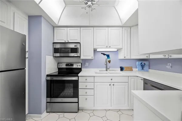 a kitchen with refrigerator and cabinets