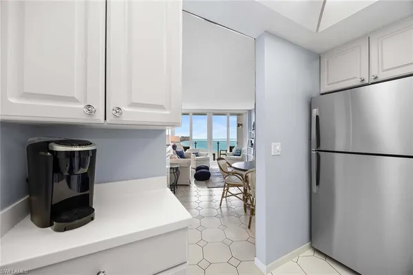 a kitchen with a refrigerator a stove a microwave and cabinets