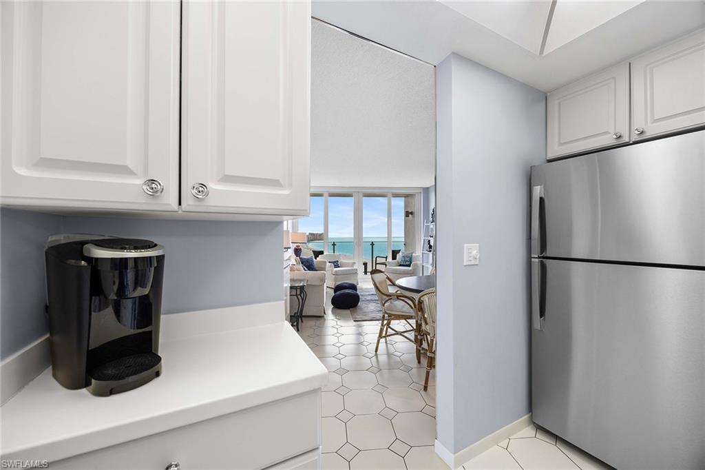 58 North Collier Boulevard, Unit 2101 Marco Island, FL 34145 - Photo 13 of 30 a kitchen with refrigerator and cabinets