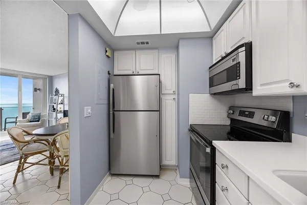 a kitchen with cabinets and white appliances