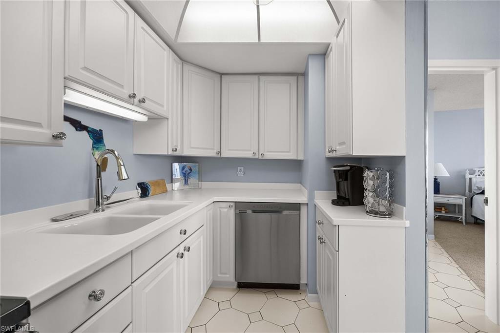 58 North Collier Boulevard, Unit 2101 Marco Island, FL 34145 - Photo 15 of 30 a kitchen with cabinets and white appliances