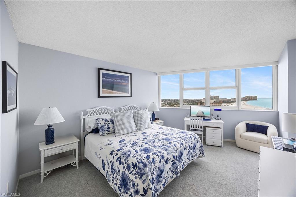 58 North Collier Boulevard, Unit 2101 Marco Island, FL 34145 - Photo 16 of 30 a bedroom with a bed and a couch