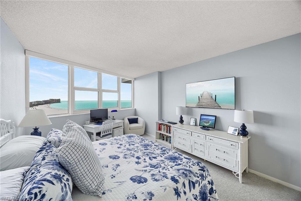 58 North Collier Boulevard, Unit 2101 Marco Island, FL 34145 - Photo 17 of 30 a bedroom with furniture and large windows
