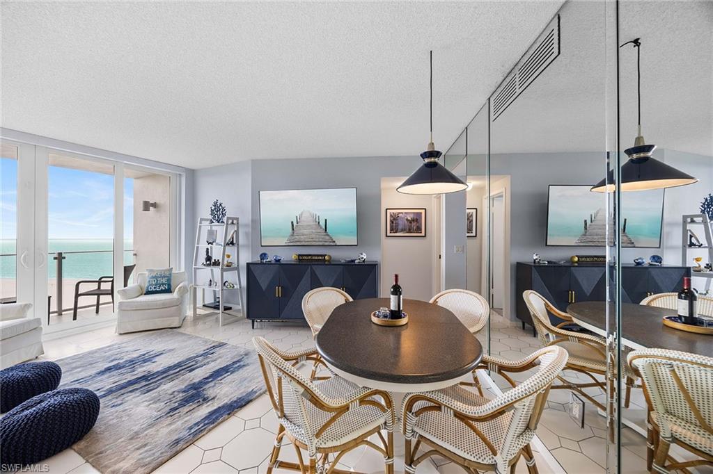 58 North Collier Boulevard, Unit 2101 Marco Island, FL 34145 - Photo 19 of 30 a dining room with furniture and wooden floor