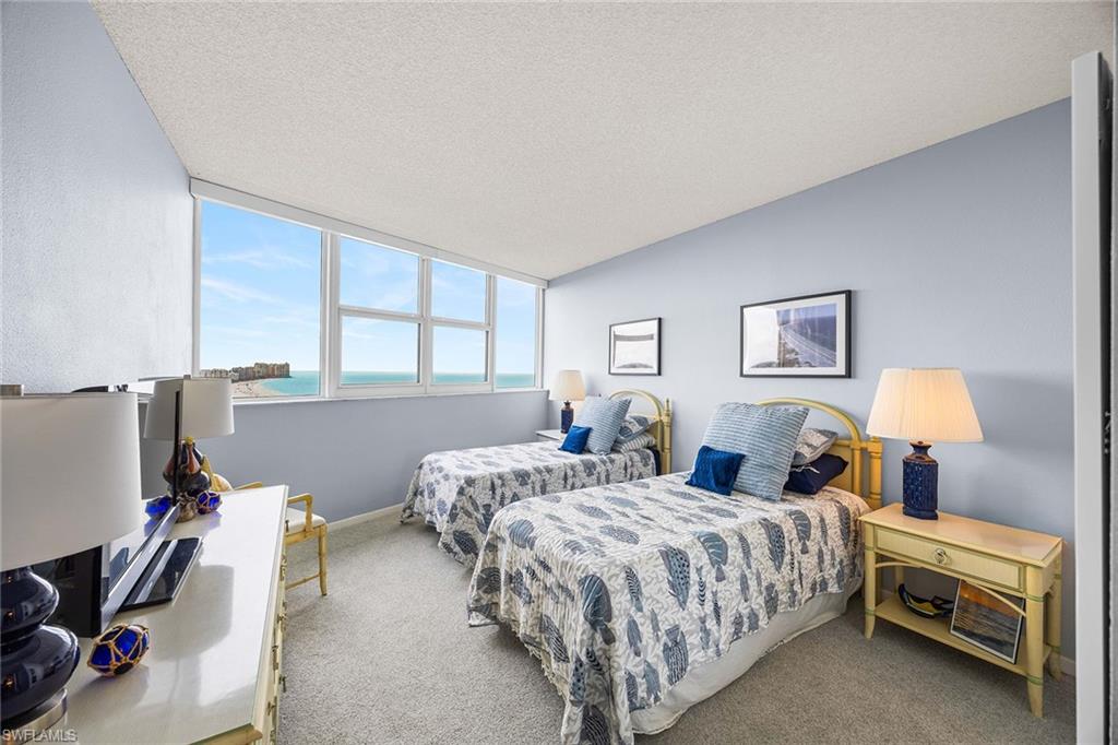 58 North Collier Boulevard, Unit 2101 Marco Island, FL 34145 - Photo 23 of 30 a bedroom with two beds and a window