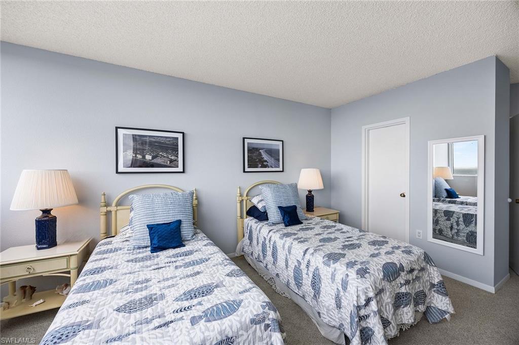 58 North Collier Boulevard, Unit 2101 Marco Island, FL 34145 - Photo 24 of 30 a bedroom with double bed and a night stand