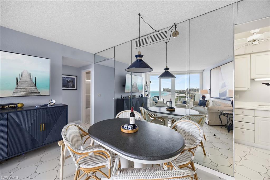 58 North Collier Boulevard, Unit 2101 Marco Island, FL 34145 - Photo 26 of 30 a living room with a couch and a chandelier