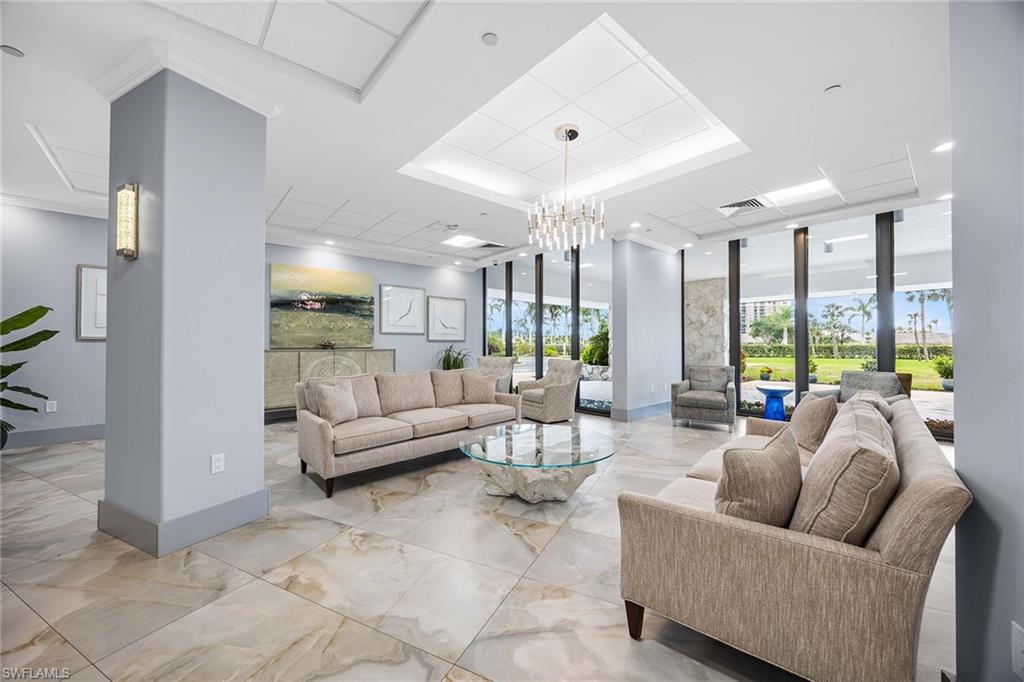 58 North Collier Boulevard, Unit 2101 Marco Island, FL 34145 - Photo 6 of 30 a living room with furniture and a large window