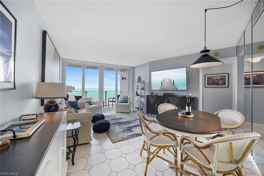 58 North Collier Boulevard, Unit 2101 Marco Island, FL 34145 - Photo 7 of 30 a living room with furniture and a large window