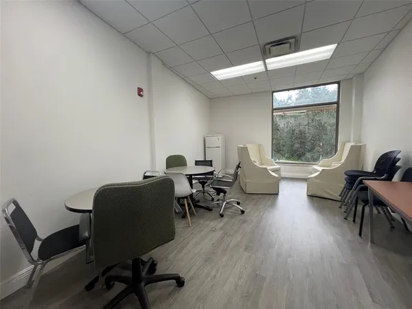 a workspace with furniture hardwood and a window
