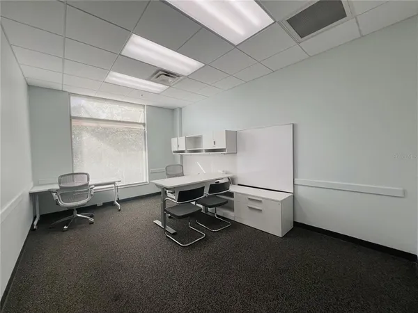 a tall building with trees in front of it