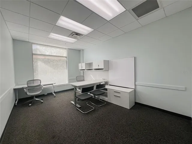 a tall building with trees in front of it