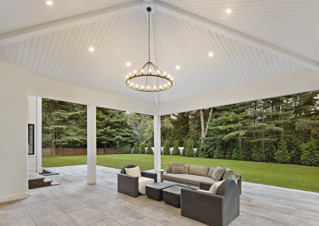 173 Stratford Road Needham, MA 02492 - Photo 4 of 6 a view of a patio with couches chairs and a big yard