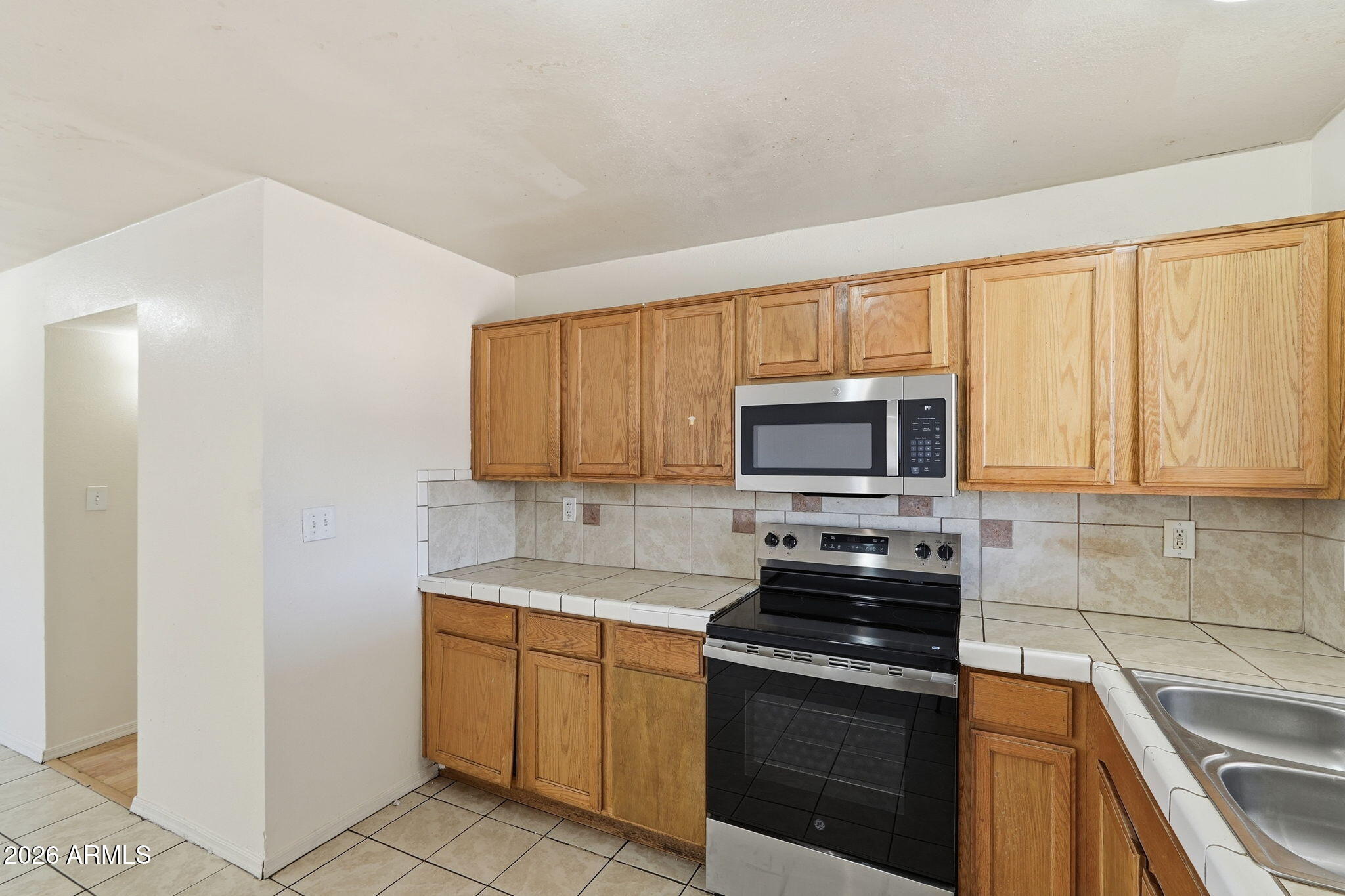6452 West Thomas Road Phoenix, AZ 85033 - Photo 12 of 30 a kitchen with a sink stove and microwave