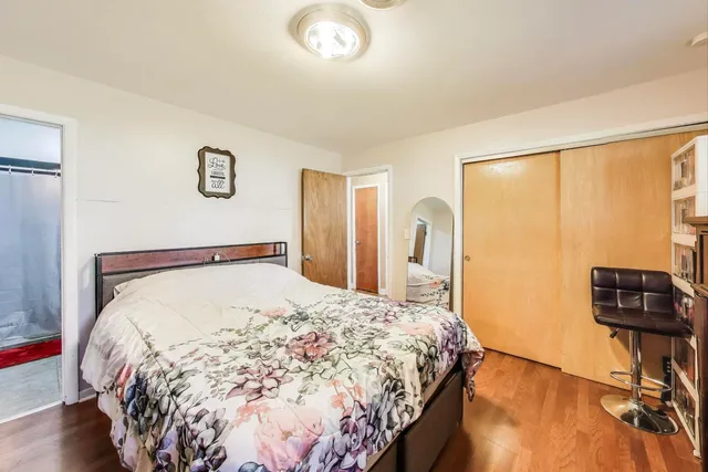 a bed sitting in a bedroom next to a window